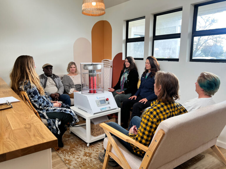 Small group gathered around a wellness device